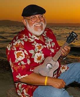 Pat playing the uke by the seashore