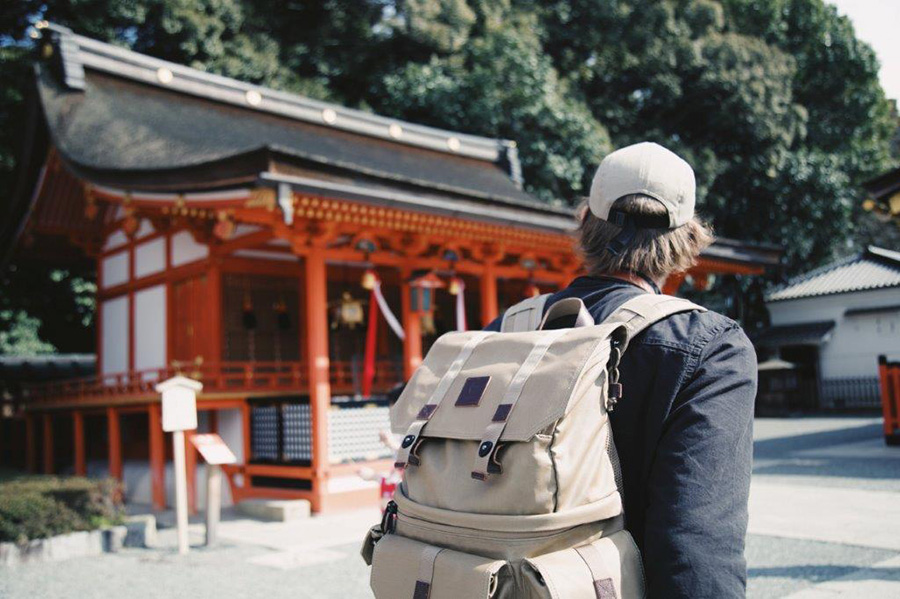 traveler in japan passing by a shrine