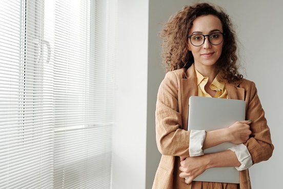 Professional woman holding laptop