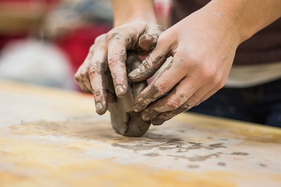 Hands working in clay