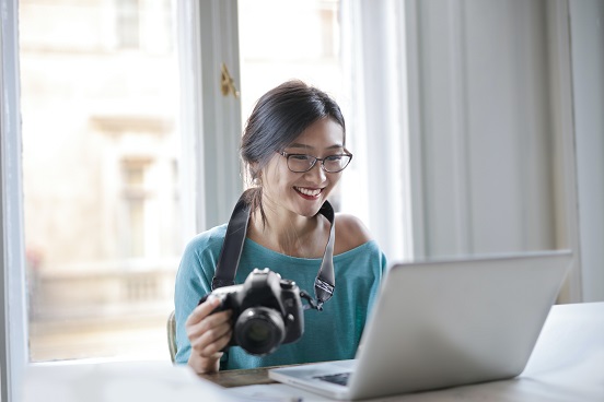 Woman with Camera and Laptop